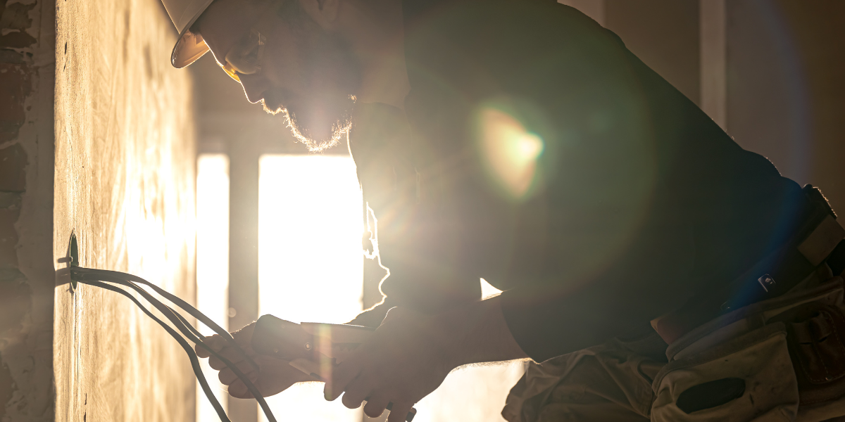 electrician fixing wiring, illustrating marketing for small electrical contractor to increase electrical service bookings