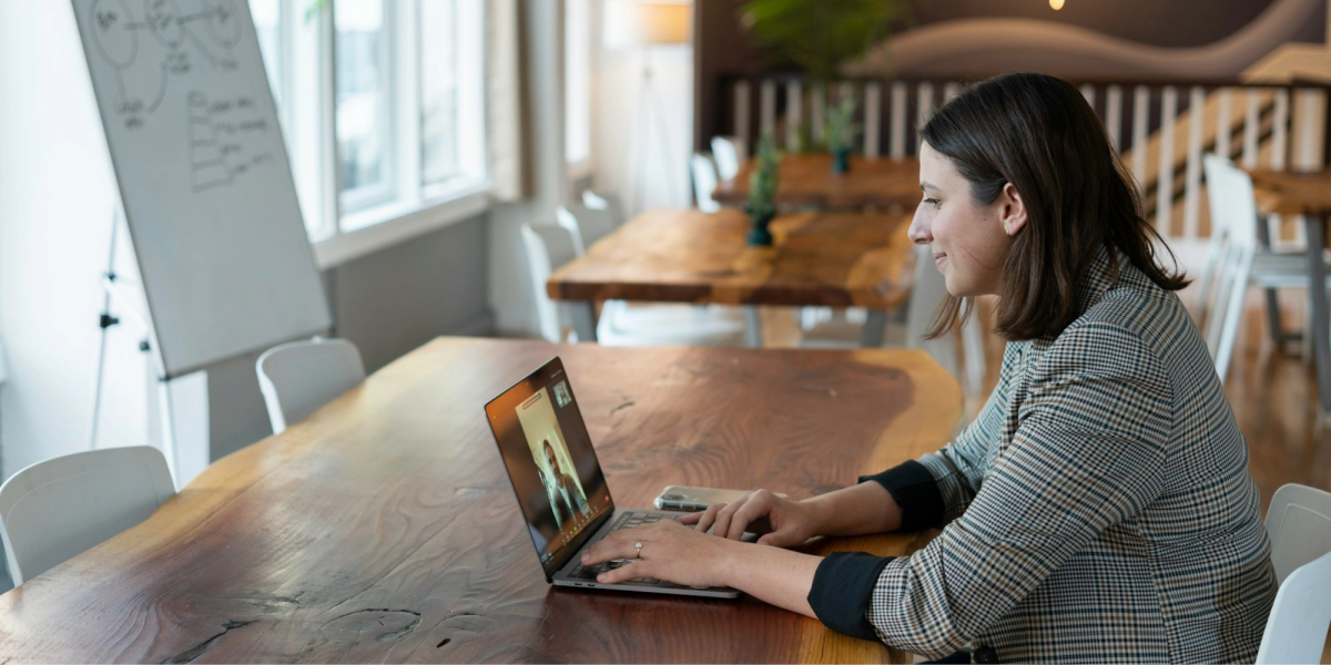 A salesperson working in an office on a virtual call