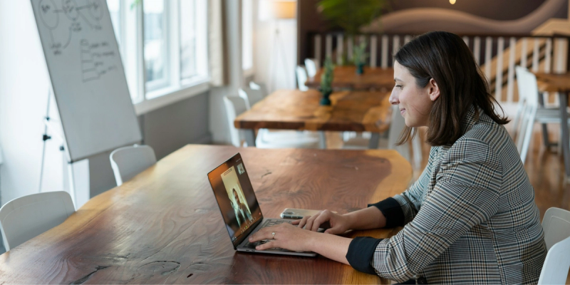 A salesperson working in an office on a virtual call