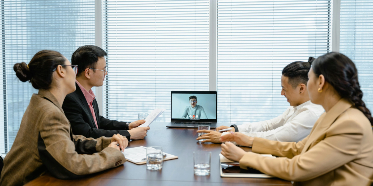 four people on a bussines meeting discussing zoom plans and pricing