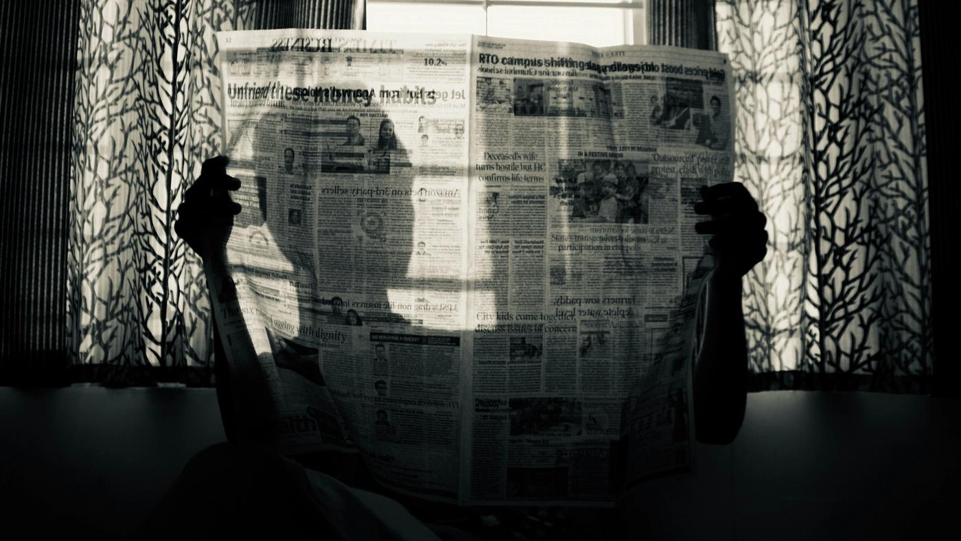 A man holding a newspaper.