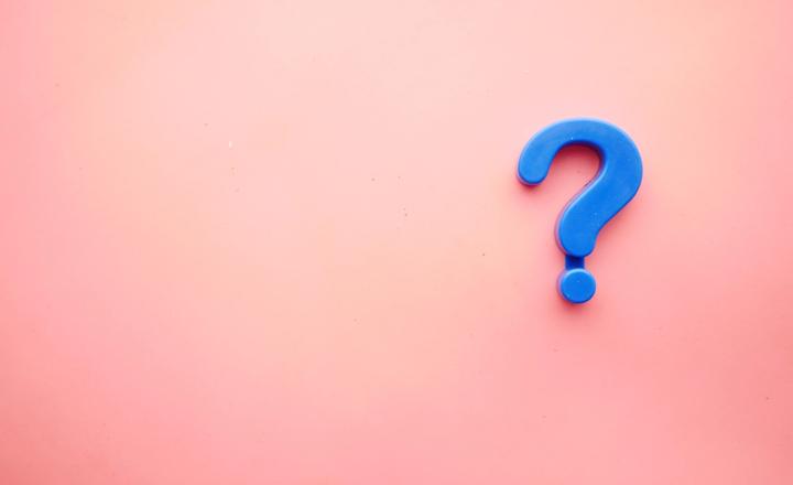 Blue question mark on a pink background