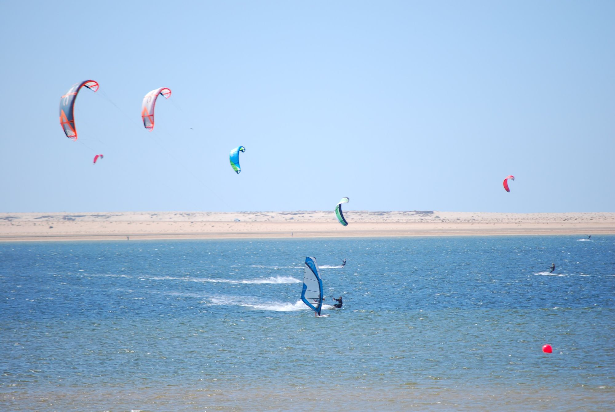 Kitesurfers and a windsurfer on the Dakhla lagoon
