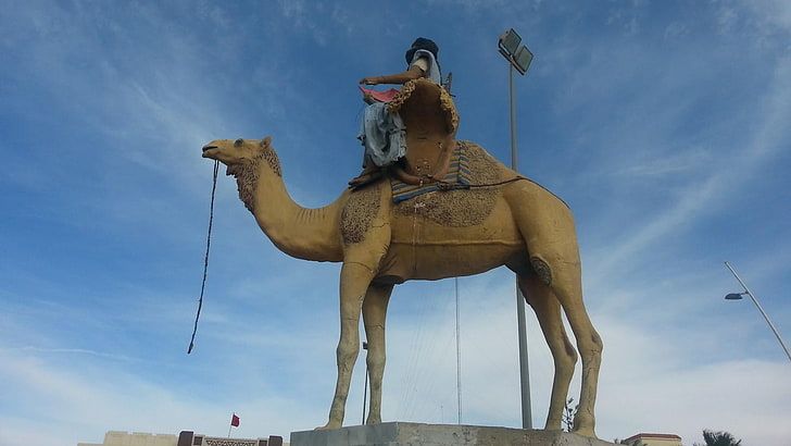 A statue of a camel and rider in Boujdour