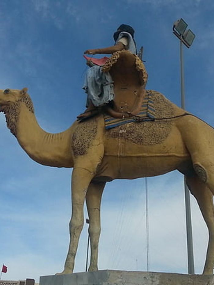 A statue of a camel and rider in Boujdour