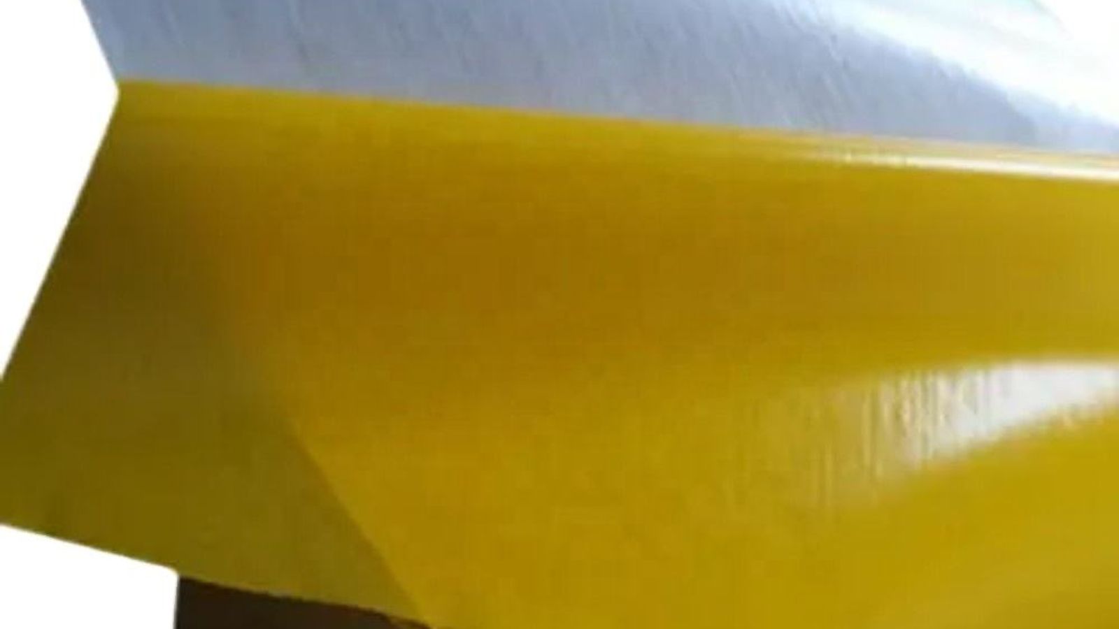 Rolls of abrasion-resistant blasting tape and a silicone masking plug positioned on a steel workpiece before sandblasting