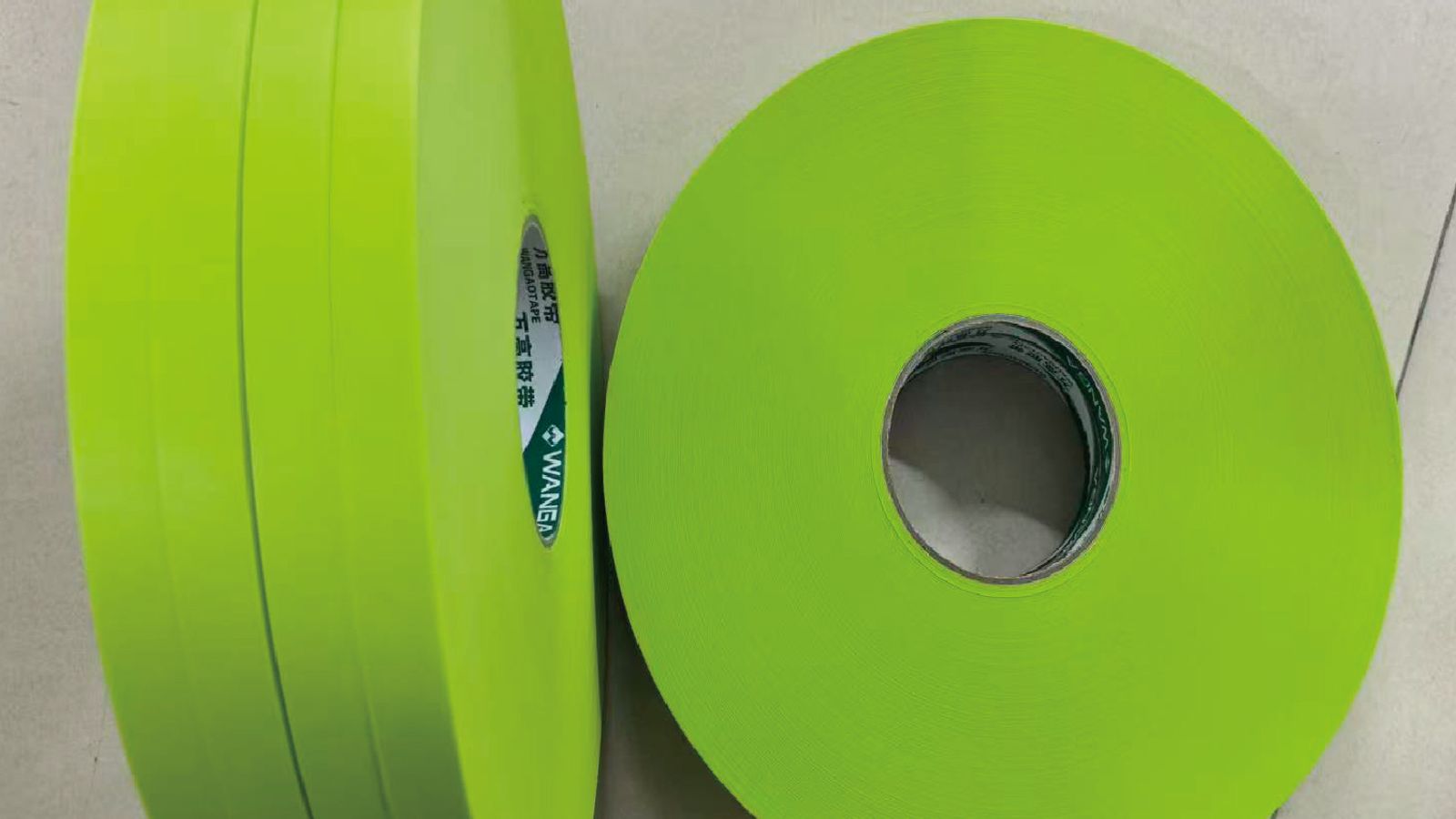 Blue HDPE masking film covering a metal part with caps protecting threaded fittings, ready for a plating bath