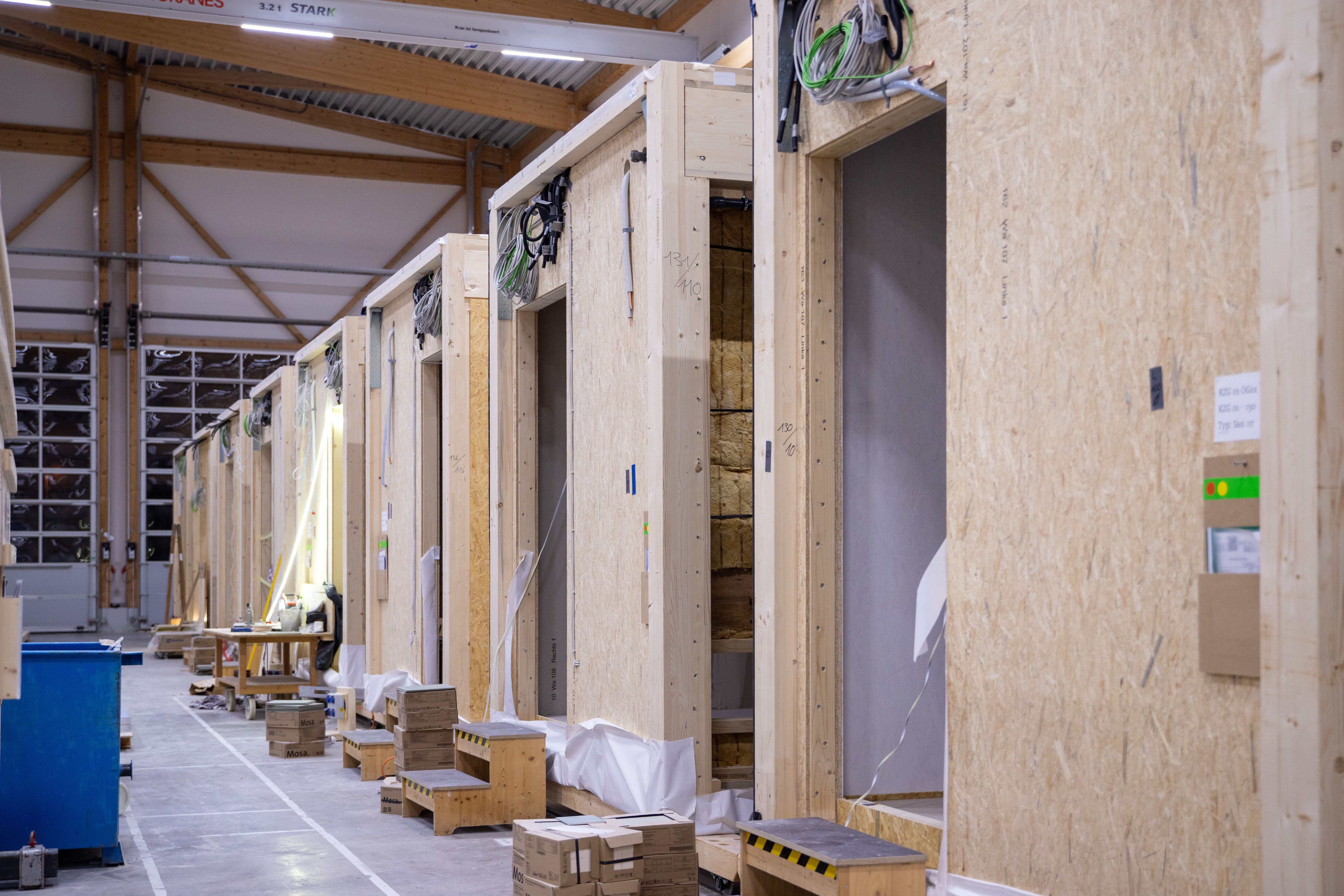 Sanitärmodule mit Kabelbündeln in der Fertigungslinie der Halle