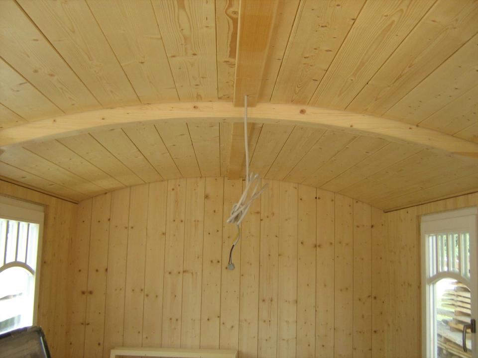 Gewölbte Holzdecke im Zirkuswagen mit Fenstern an beiden Enden