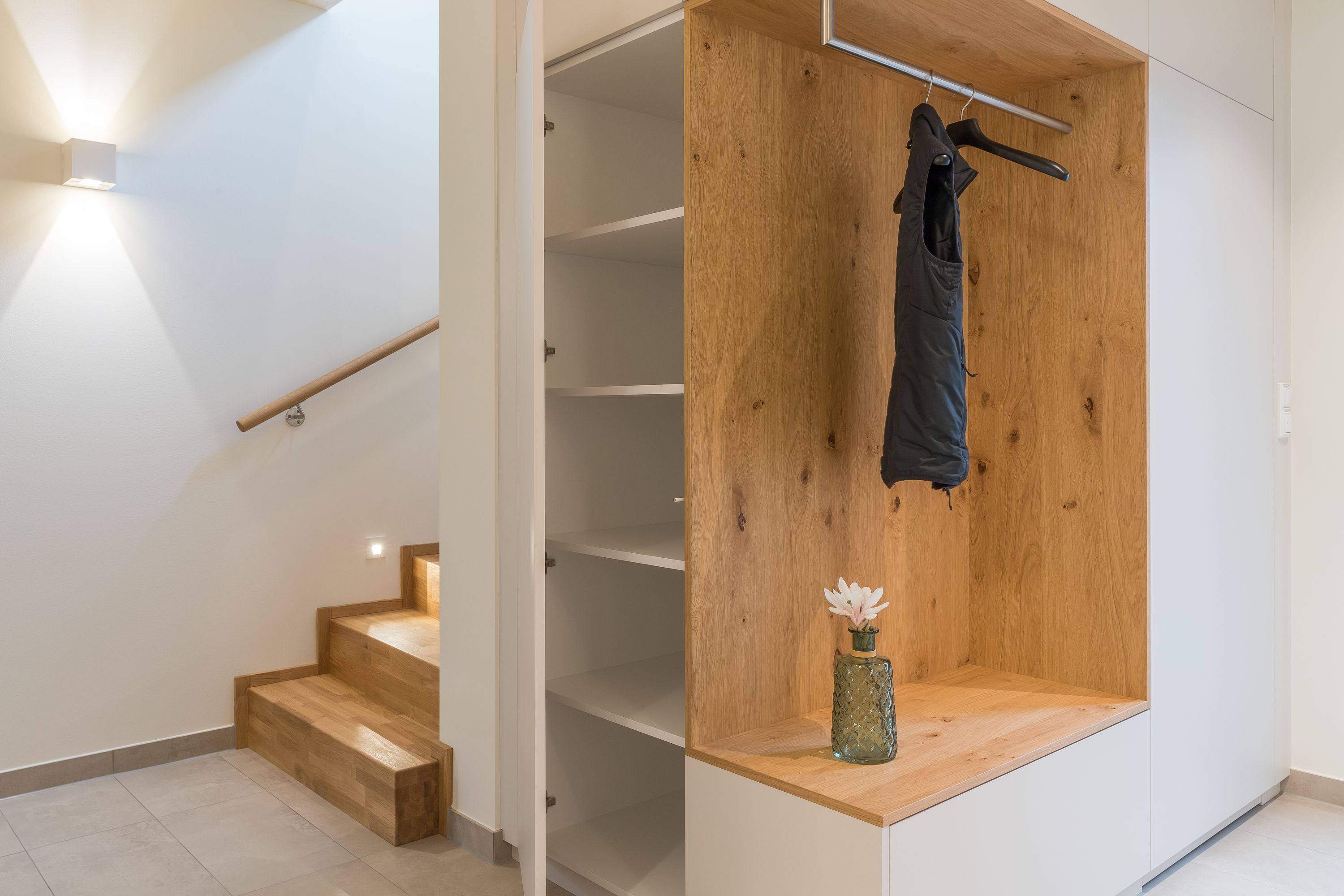 Eingebaute Garderobe mit offenem Schuhschrank neben der Treppe
