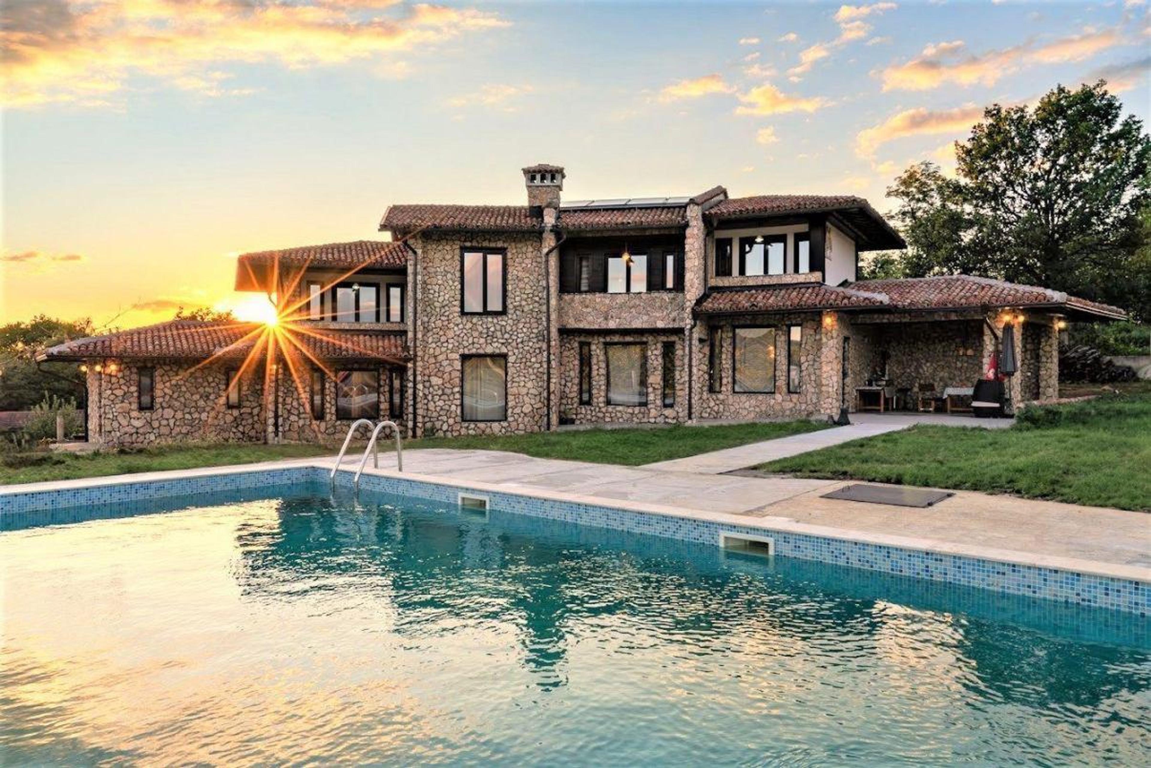 Charming stone house with a pool for sale in Sofia – luxury real estate in Bulgaria ideal for living or investment.