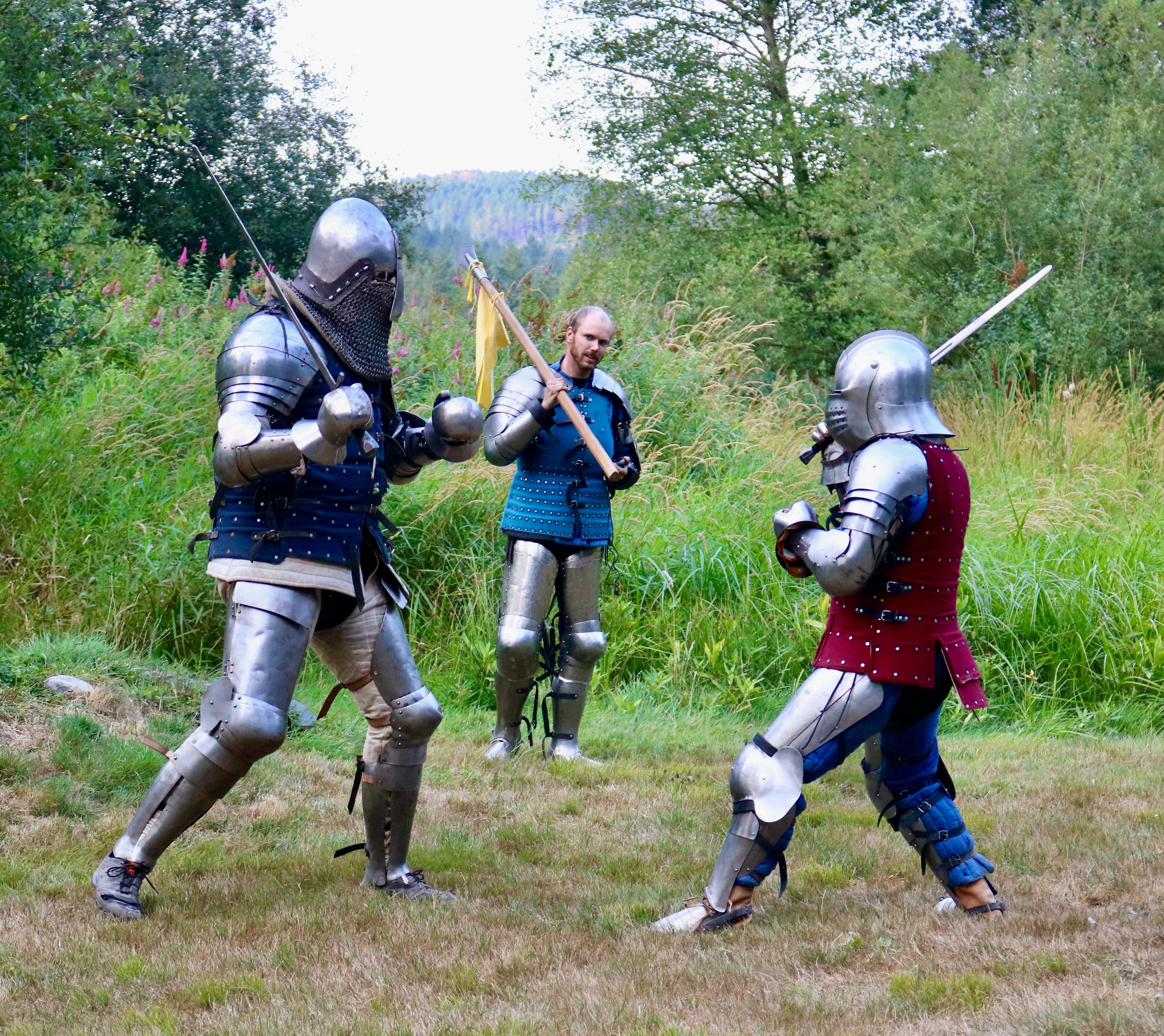 People in armor stage a mock swordfight