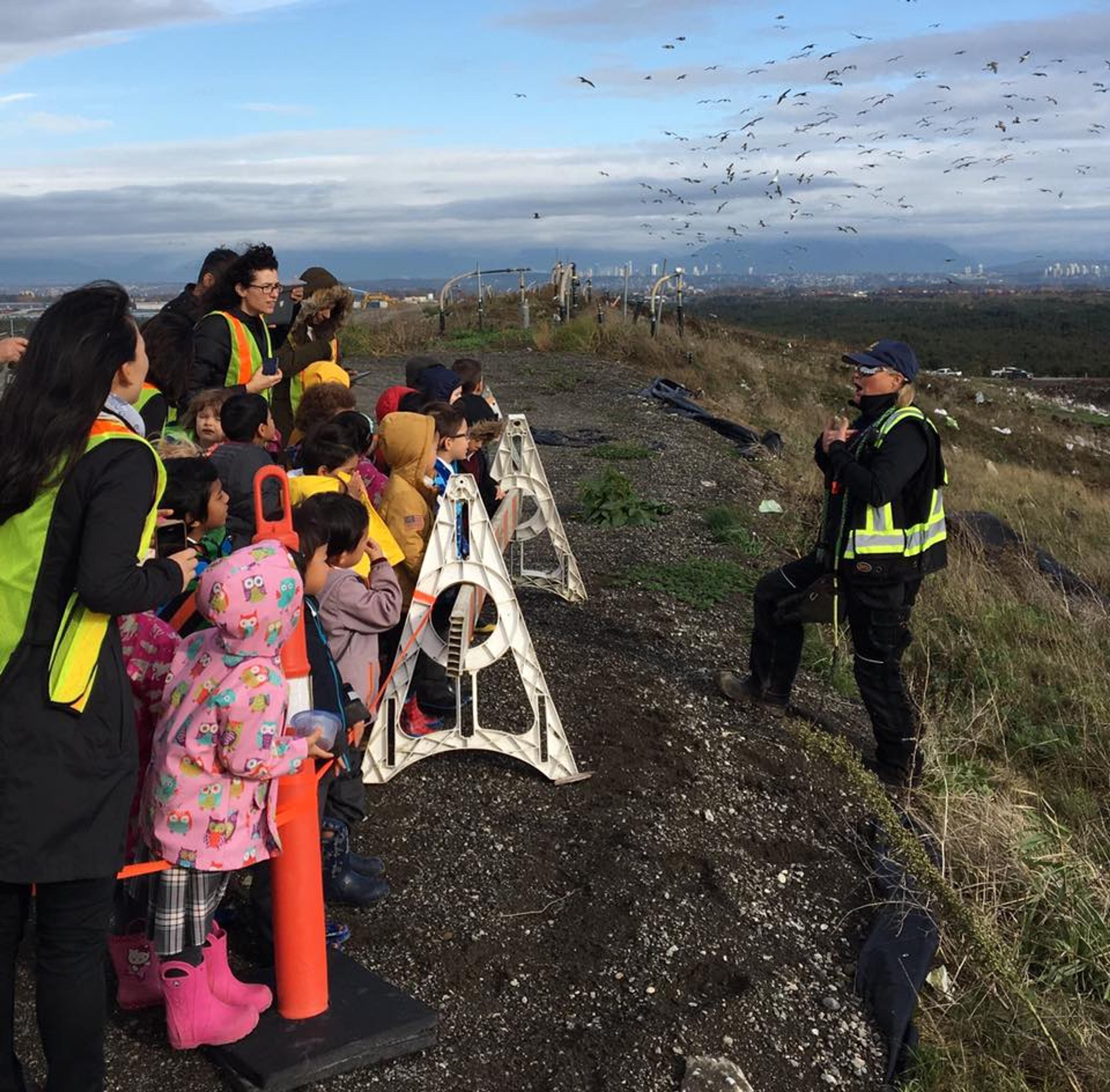 Raptors employee at a landfill talking to a tour group