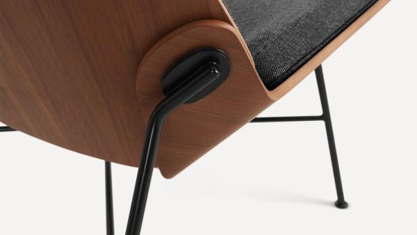 Close up image of wood chair base connecting to metal legs