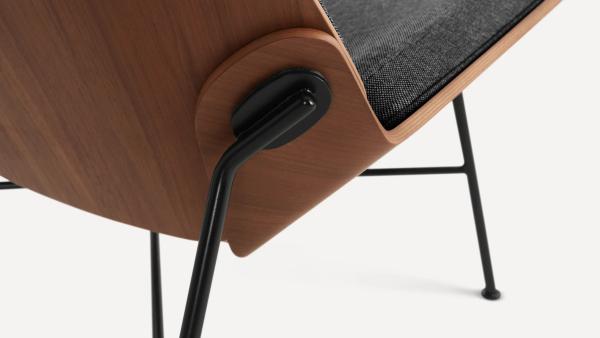 Close up image of wood chair base connecting to metal legs
