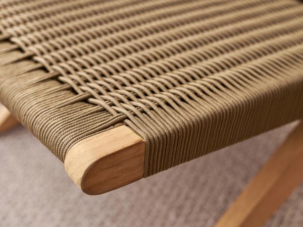 Close up of teak chair seat showcasing its material