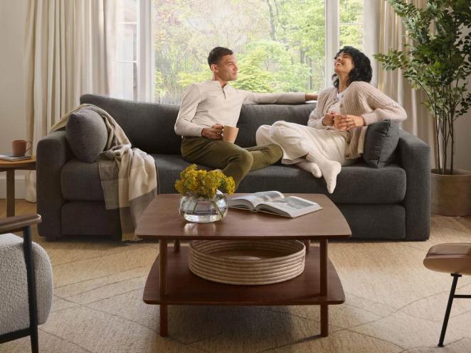 couple relaxing and laughing on a Burrow sofa
