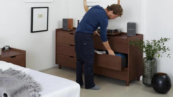 Man opening a dresser drawer