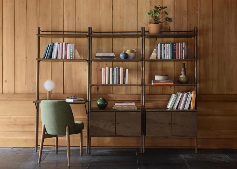 Title storage in walnut with books on shelves and a chair at the Title desk