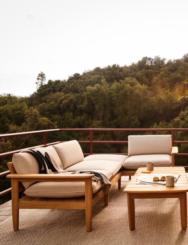 Teak outdoor sectional with coffee table on a balcony