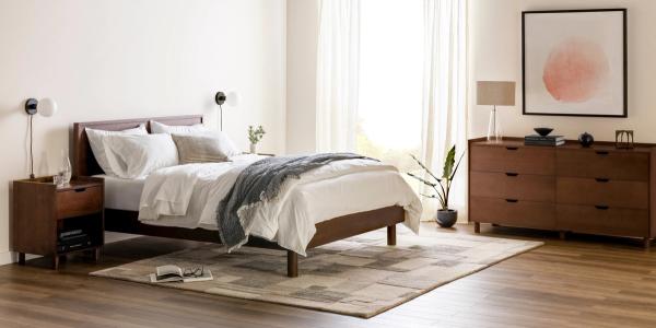 bedroom scene with bed, dresser, and nightstand