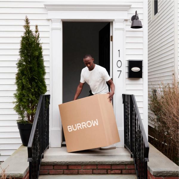 Man with a Burrow box on front porch