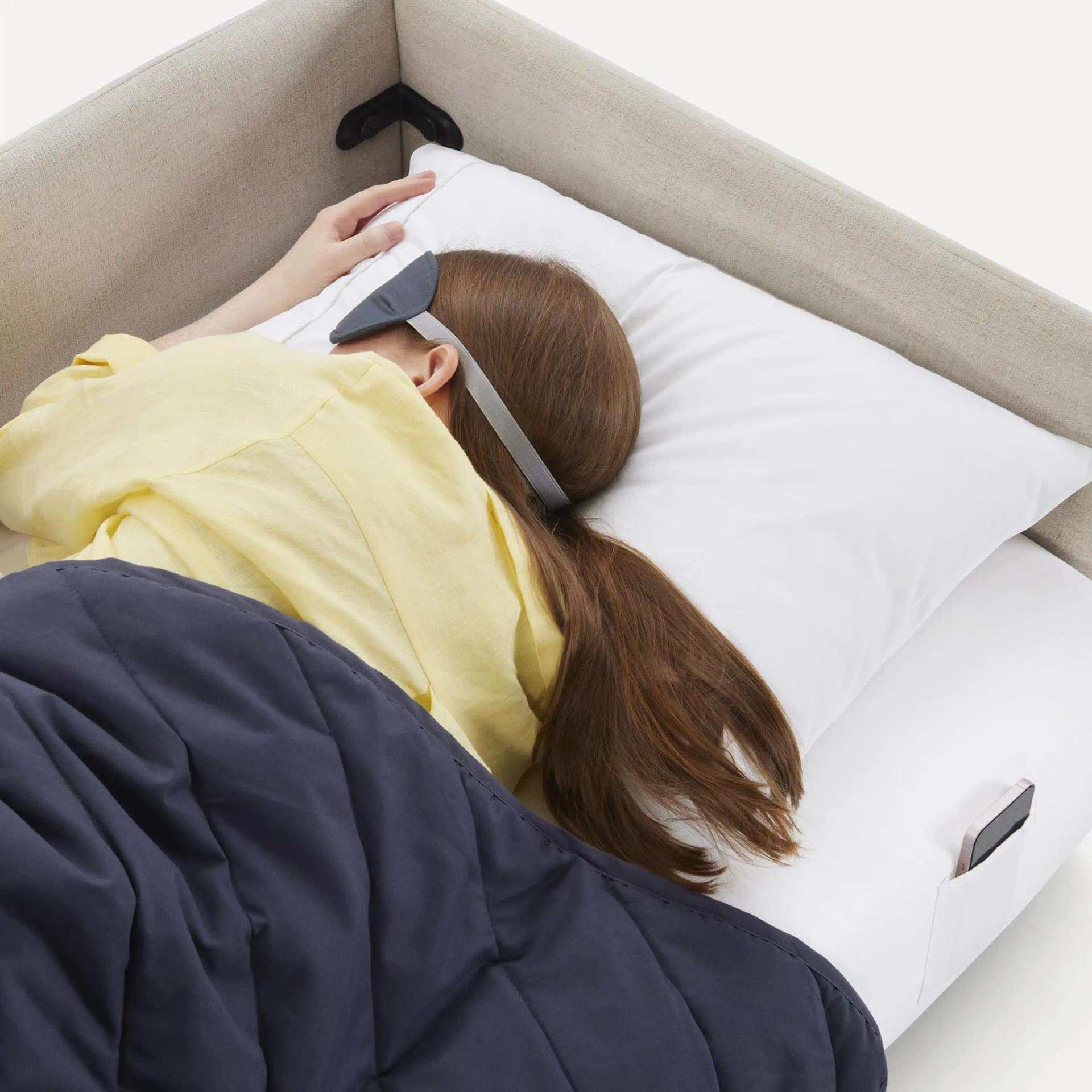 woman with eye mask sleeping on sleep kit