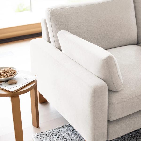 Close up shot of a white sofa arm and side pillow