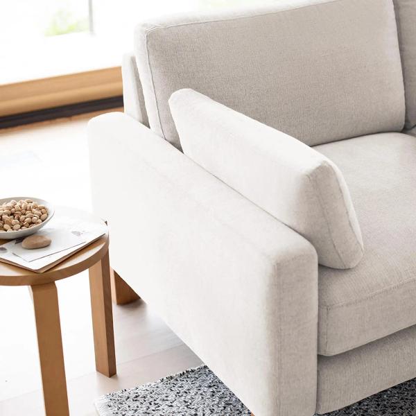 Close up shot of a white sofa arm and side pillow