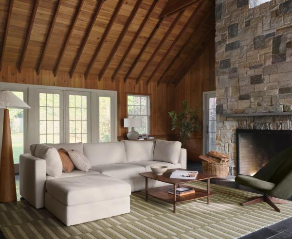 3-piece sofa with ottoman and walnut coffee table on green striped rug