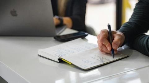 Man writing on notebook