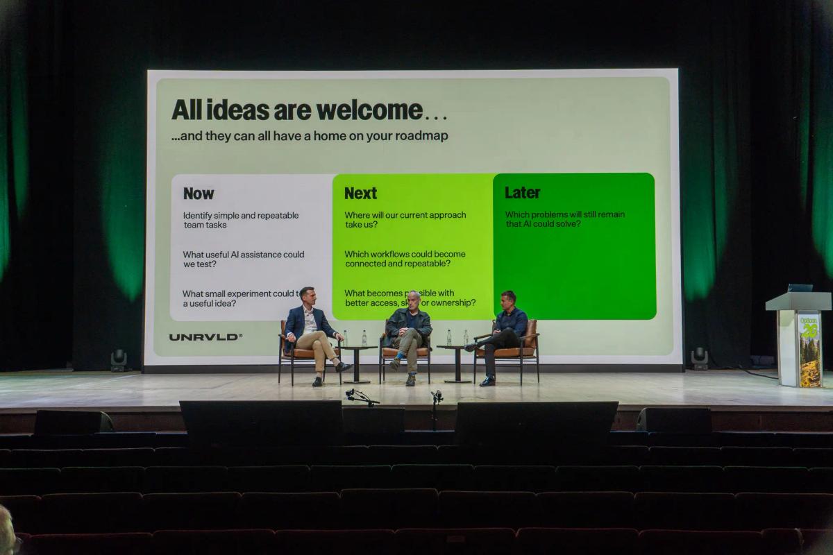 UNRVLD on stage at Opticon 2026 with a global financial services client, discussing the now, next and later framework to adopting an AI orchestration platform