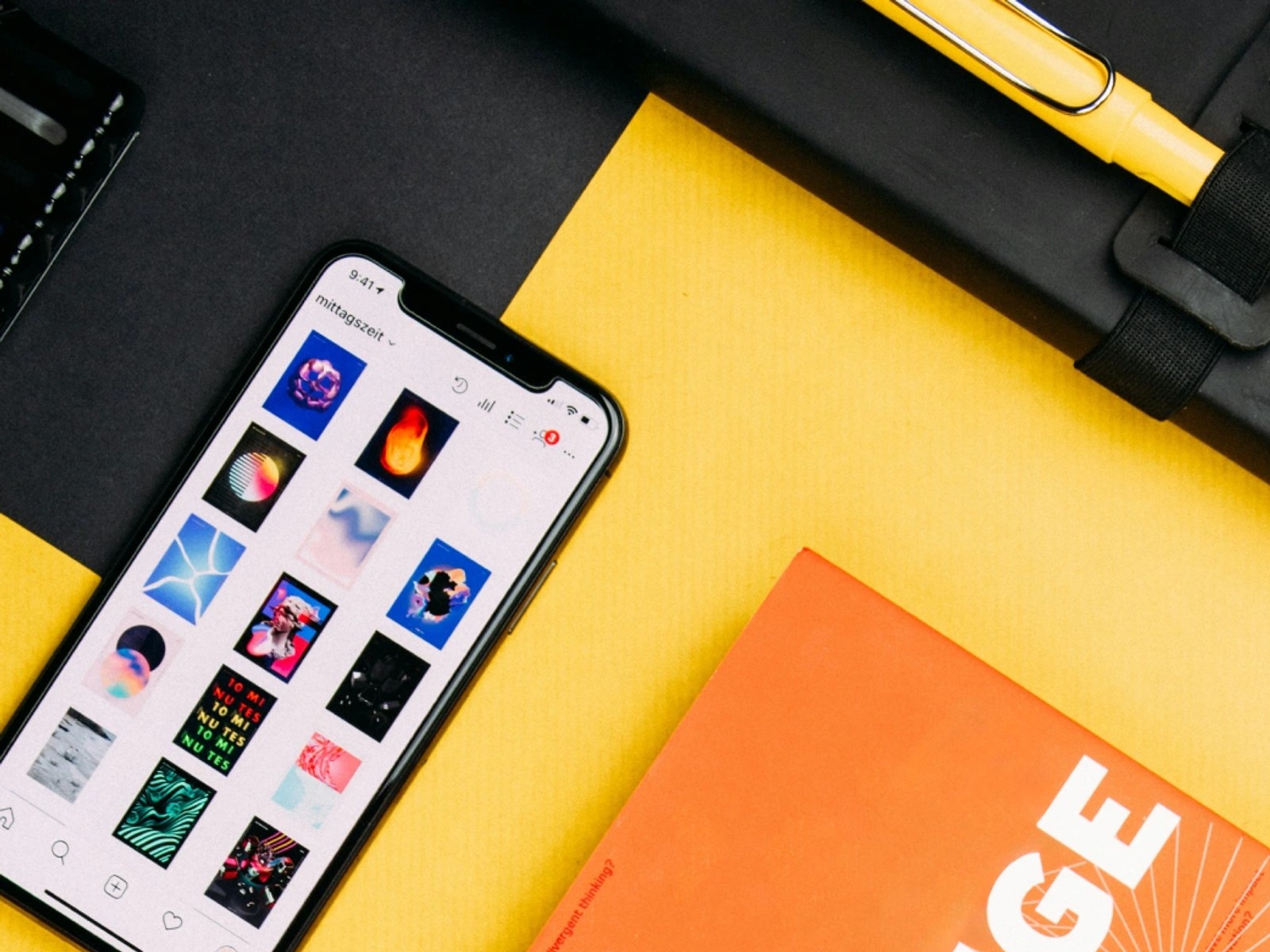 Flat lay of a phone showing an Instagram grid next to an orange magazine with bold "CHANGE" cover typography.