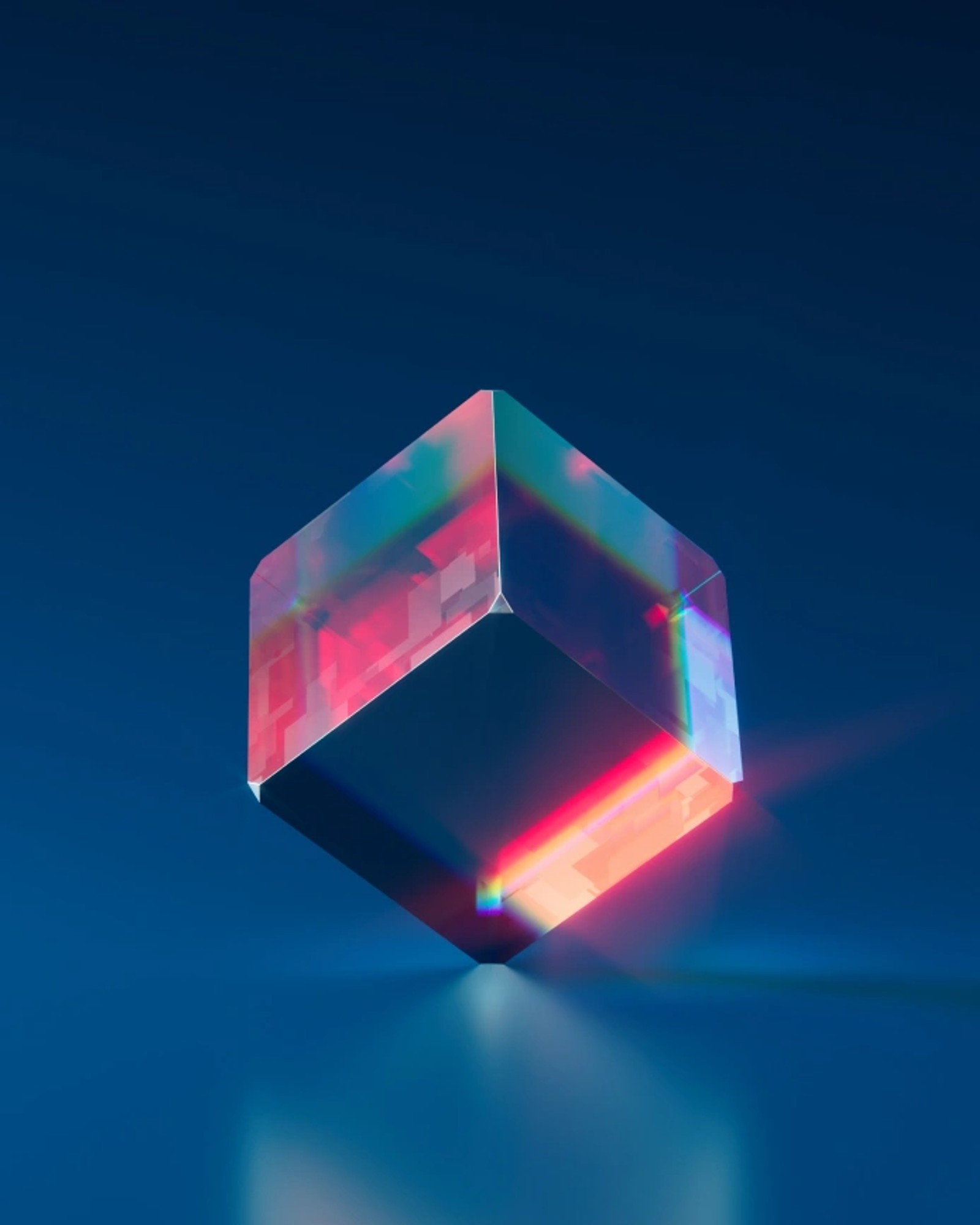 Translucent glass cube refracting pink and red light against a deep blue background.