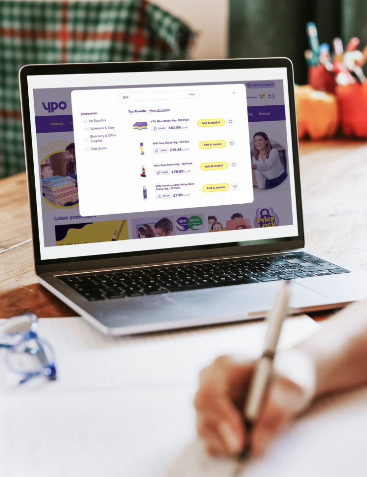 A laptop screen showing the YPO commerce site with product search results, category navigation, and pricing - representing a digital procurement experience for public sector buyers.