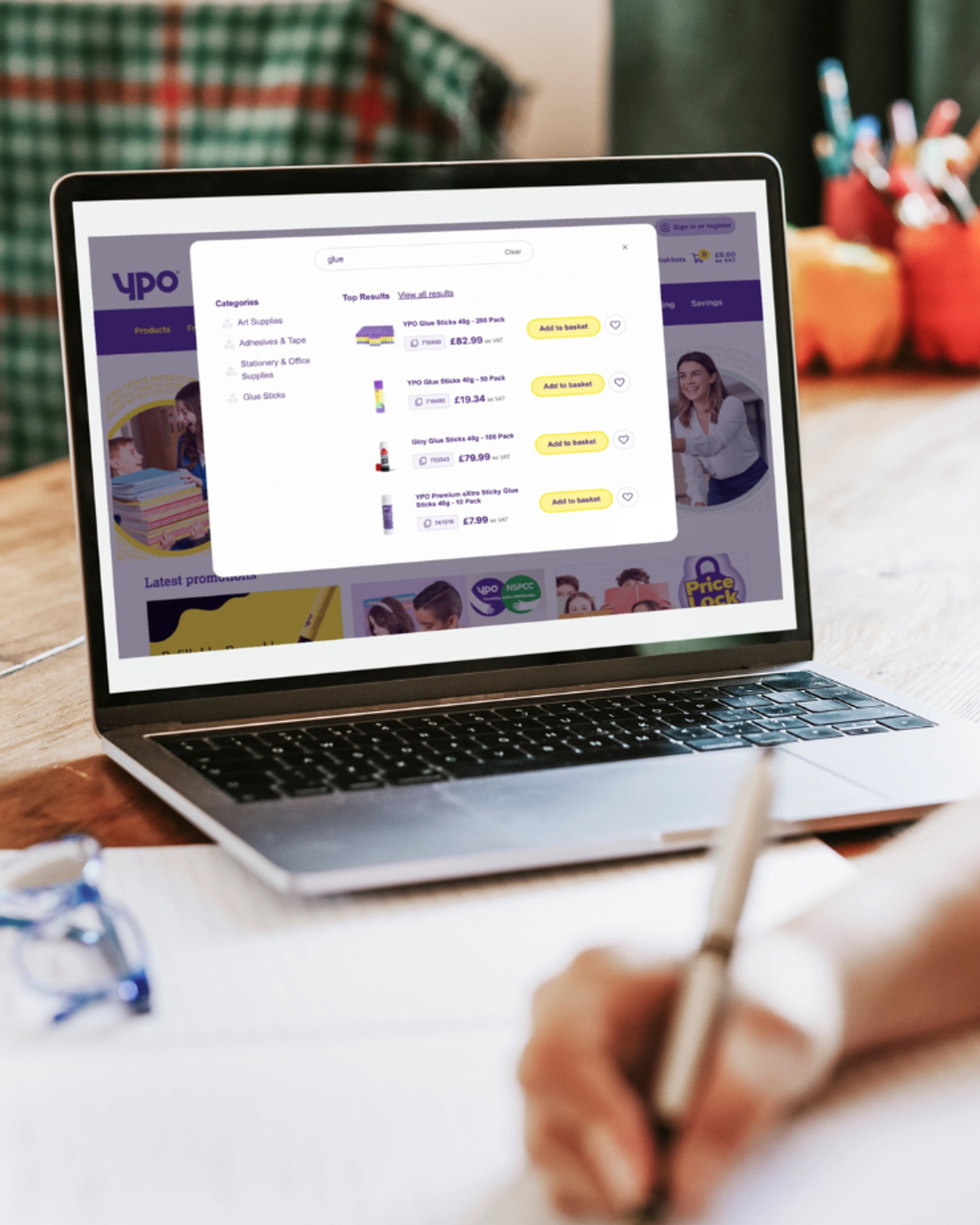 A laptop screen showing the YPO commerce site with product search results, category navigation, and pricing - representing a digital procurement experience for public sector buyers.