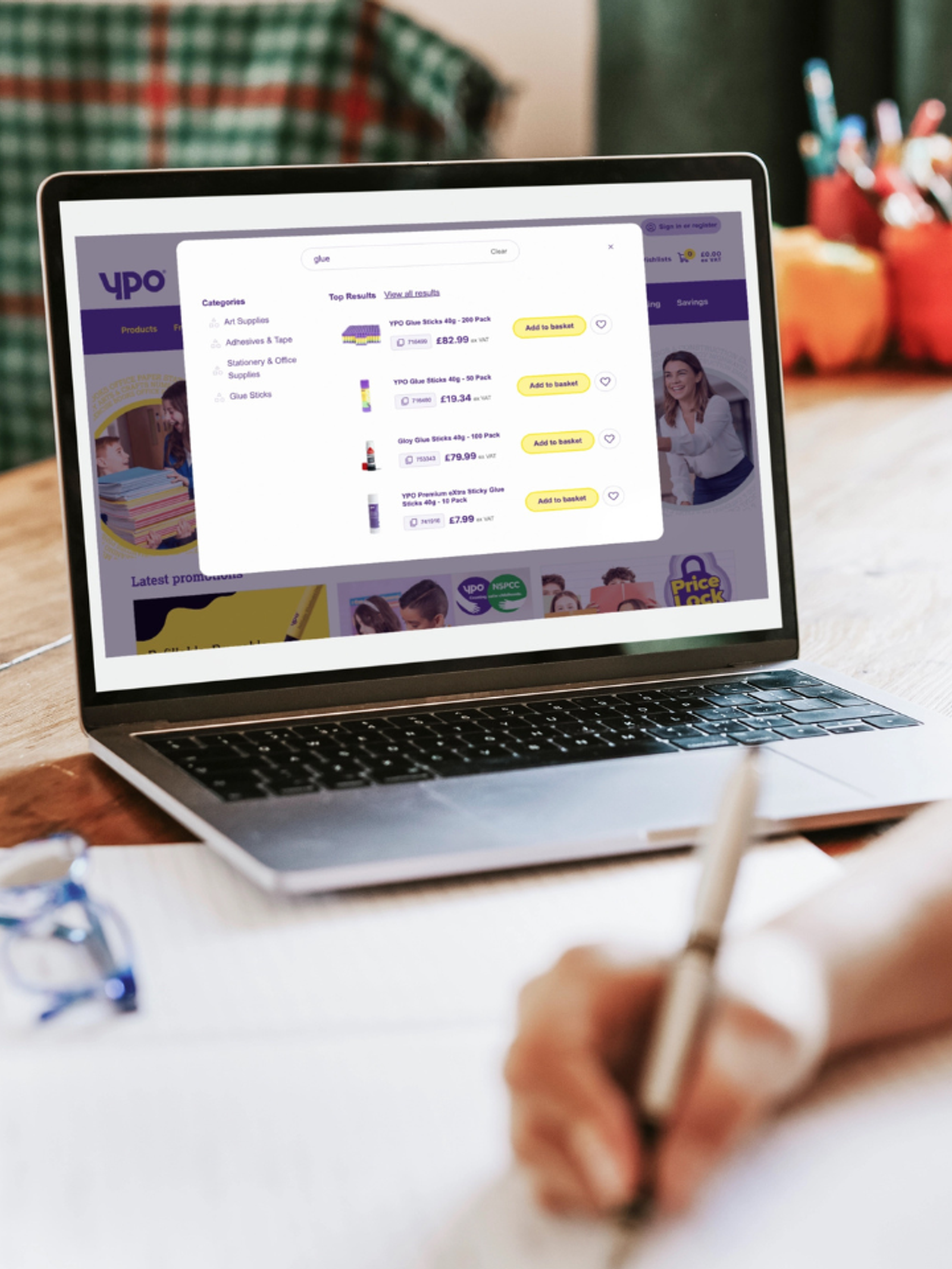 A laptop screen showing the YPO commerce site with product search results, category navigation, and pricing - representing a digital procurement experience for public sector buyers.