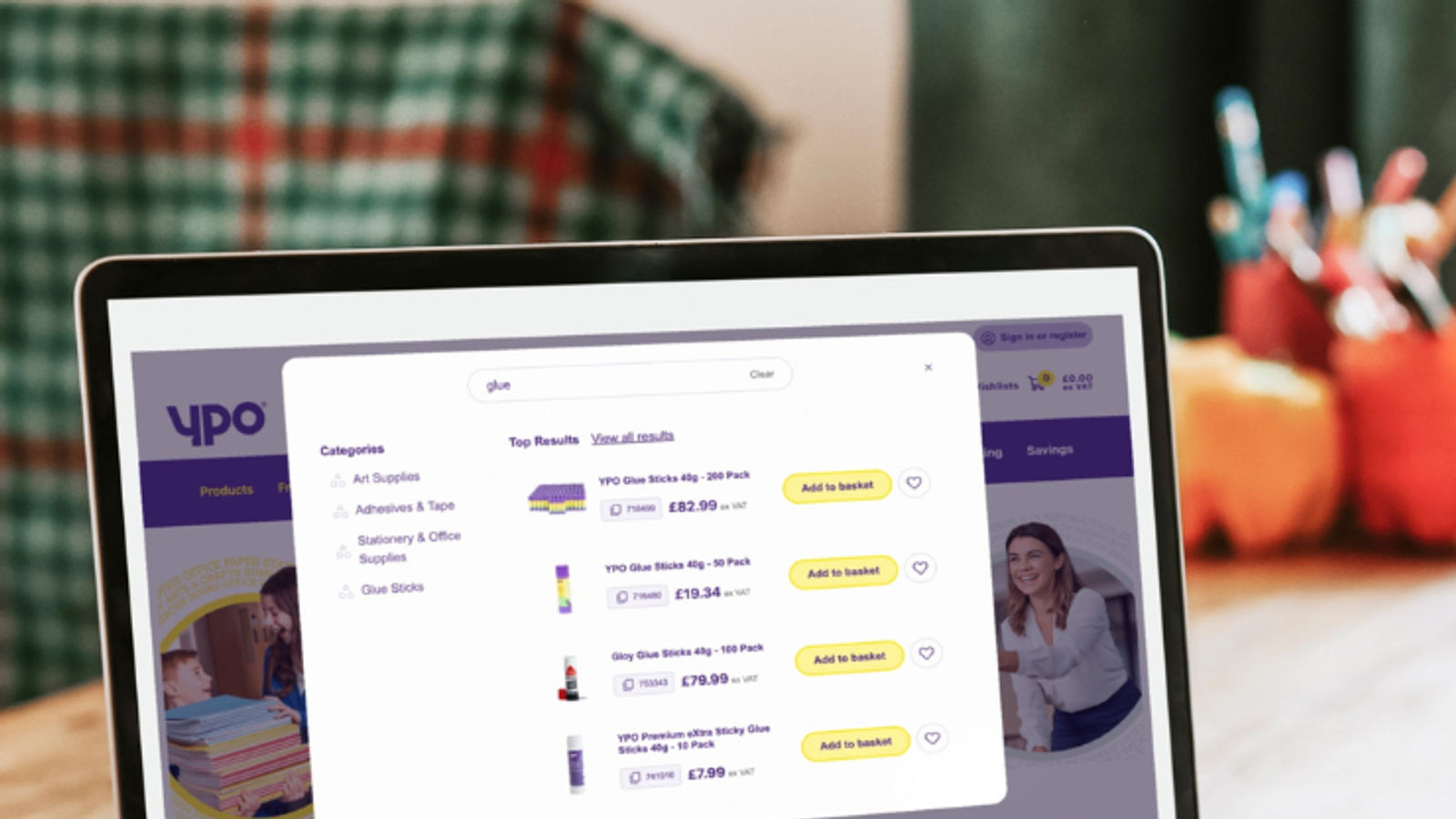 A laptop screen showing the YPO commerce site with product search results, category navigation, and pricing - representing a digital procurement experience for public sector buyers.