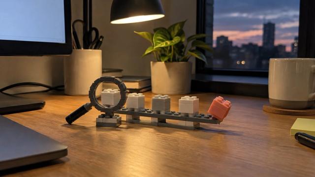 Toy-brick deal blocks on a pipeline rail under a brick magnifying glass, one coral-pink block tipping off the rail