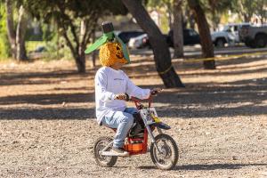 Pumpkin-head Carlos on mini-e-bike