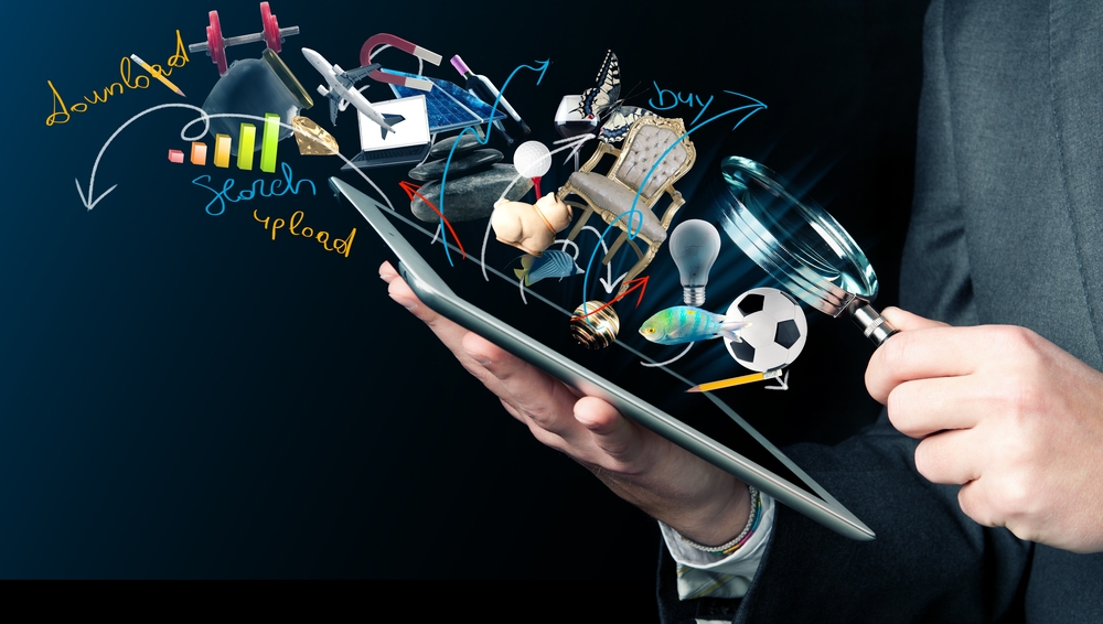 Image Social media icons rising from a tablet held in two hands