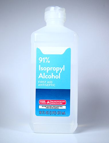 A clear plastic bottle labeled “91% Isopropyl Alcohol First Aid Antiseptic,” 16 fl oz (473 ml), with safety warnings on the lower part of the blue and white label.