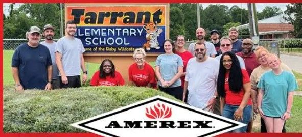 A group of adults pose and smile in front of a sign reading “Tarrant Elementary School” with trees in the background. An Amerex logo is visible at the bottom of the image.