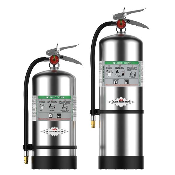 Two stainless steel Amerex fire extinguishers stand upright, one short and one tall, each with a black hose, instruction label, and pressure gauge on top.
