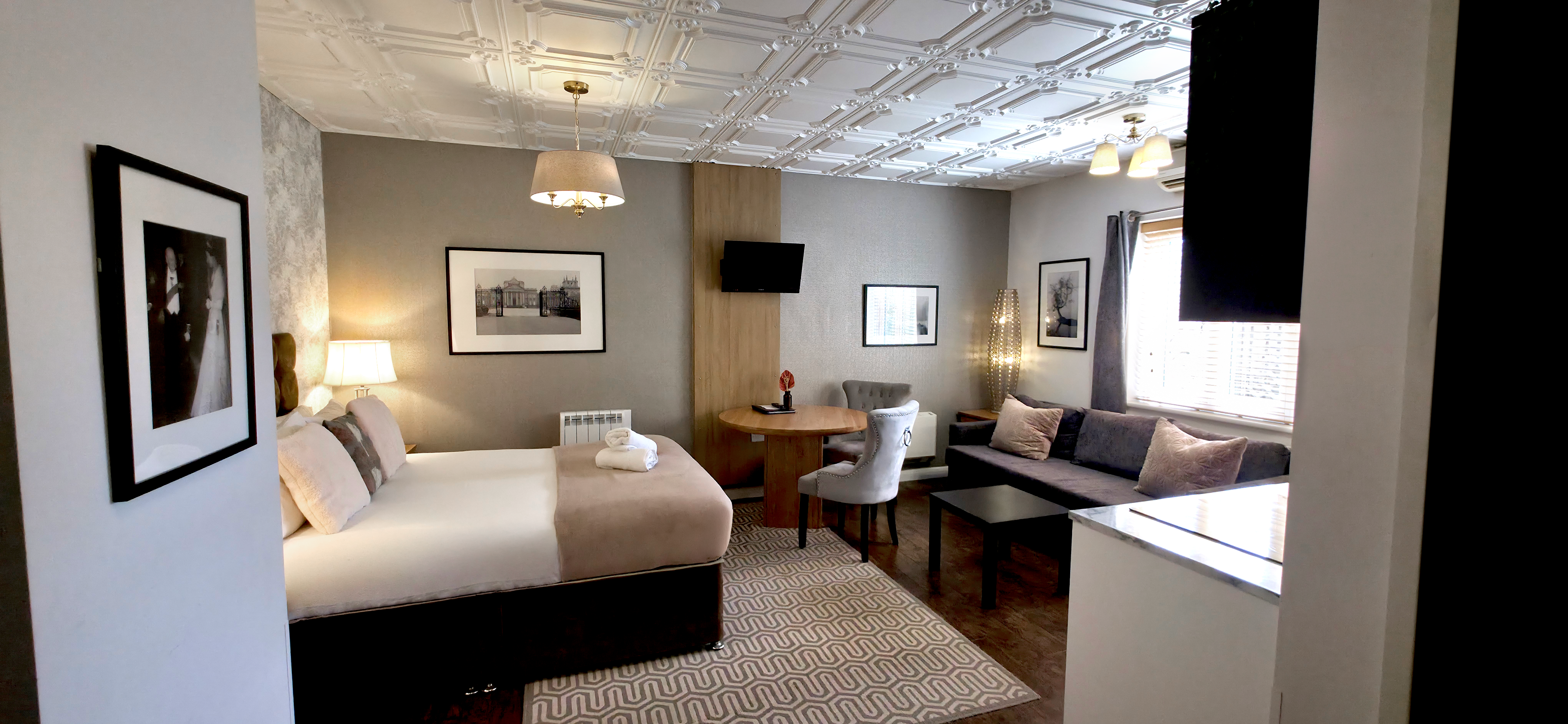Studio with a king size bed, digital TV, dining table, sofa & kitchenette 
