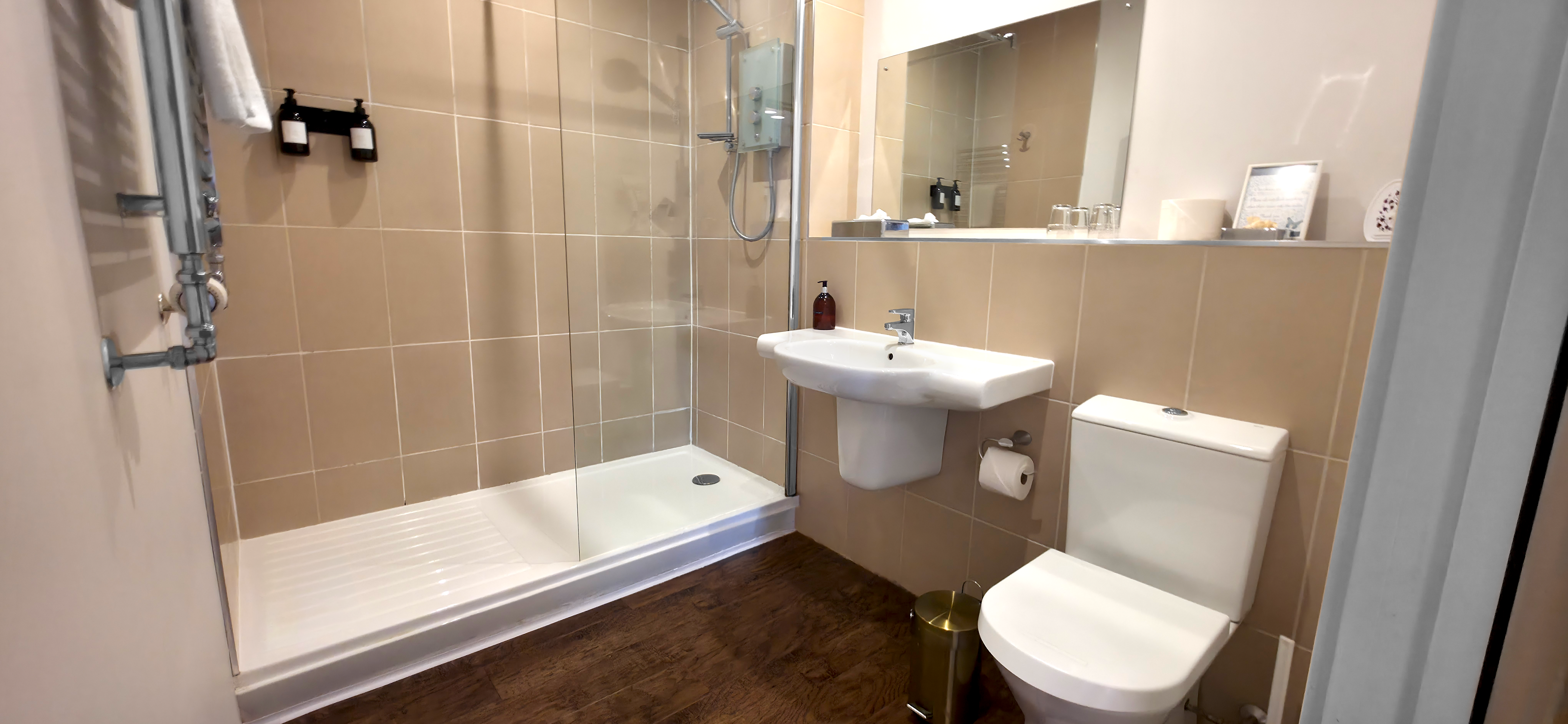 Walk in shower with glass screen, toilet & heated towel rail & chrome fittings