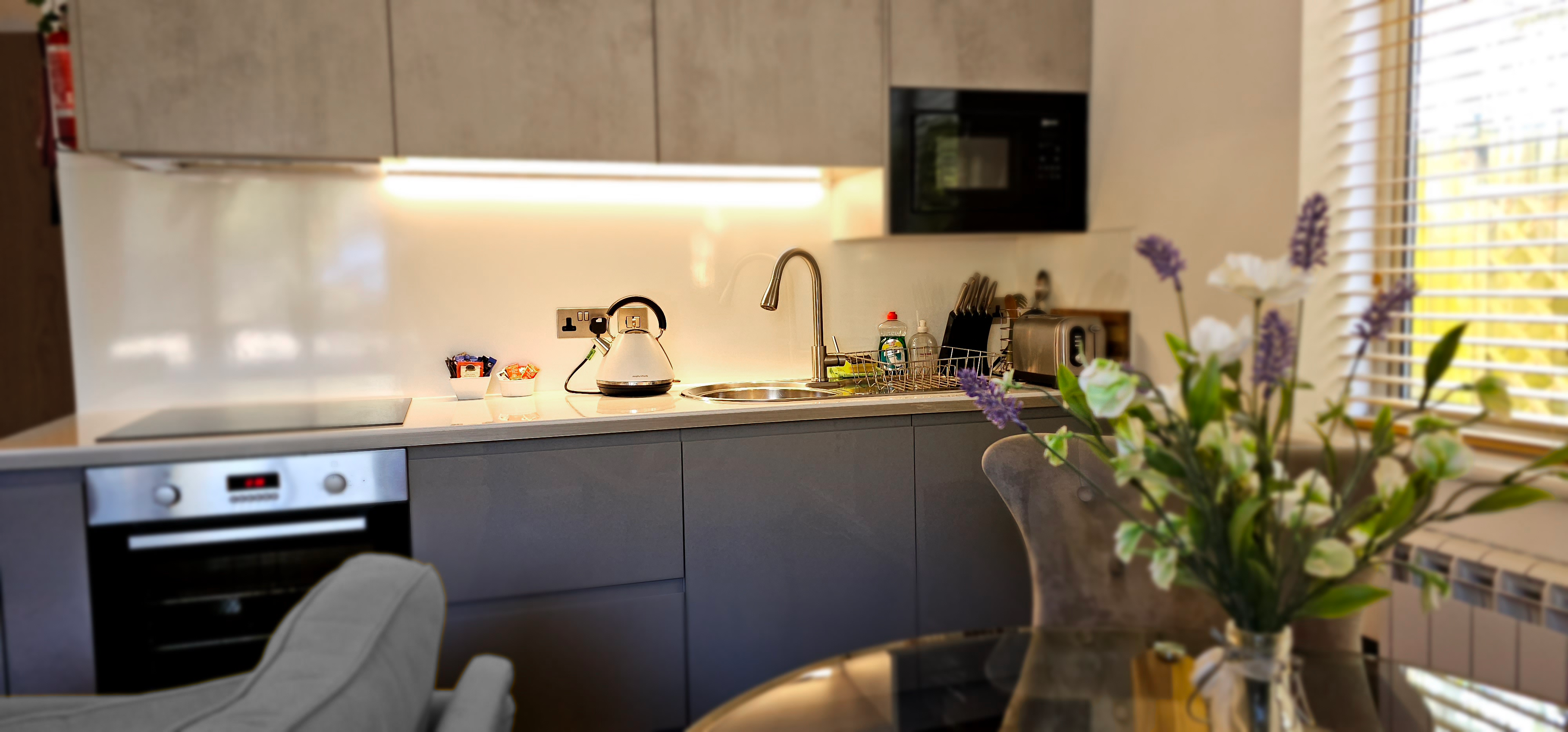 Full kitchenette with oven, hobs, sink, toaster, kettle & microwave