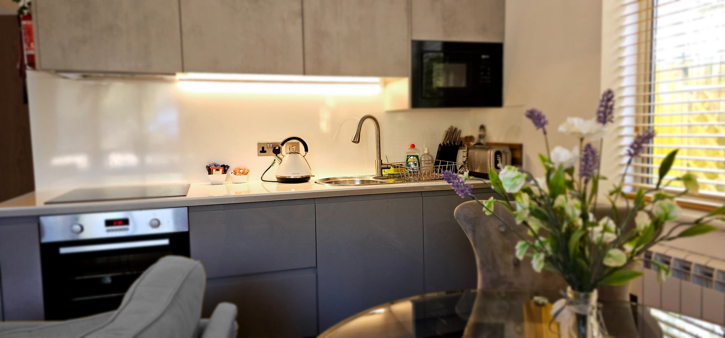 Full kitchenette with oven, hobs, sink, toaster, kettle & microwave