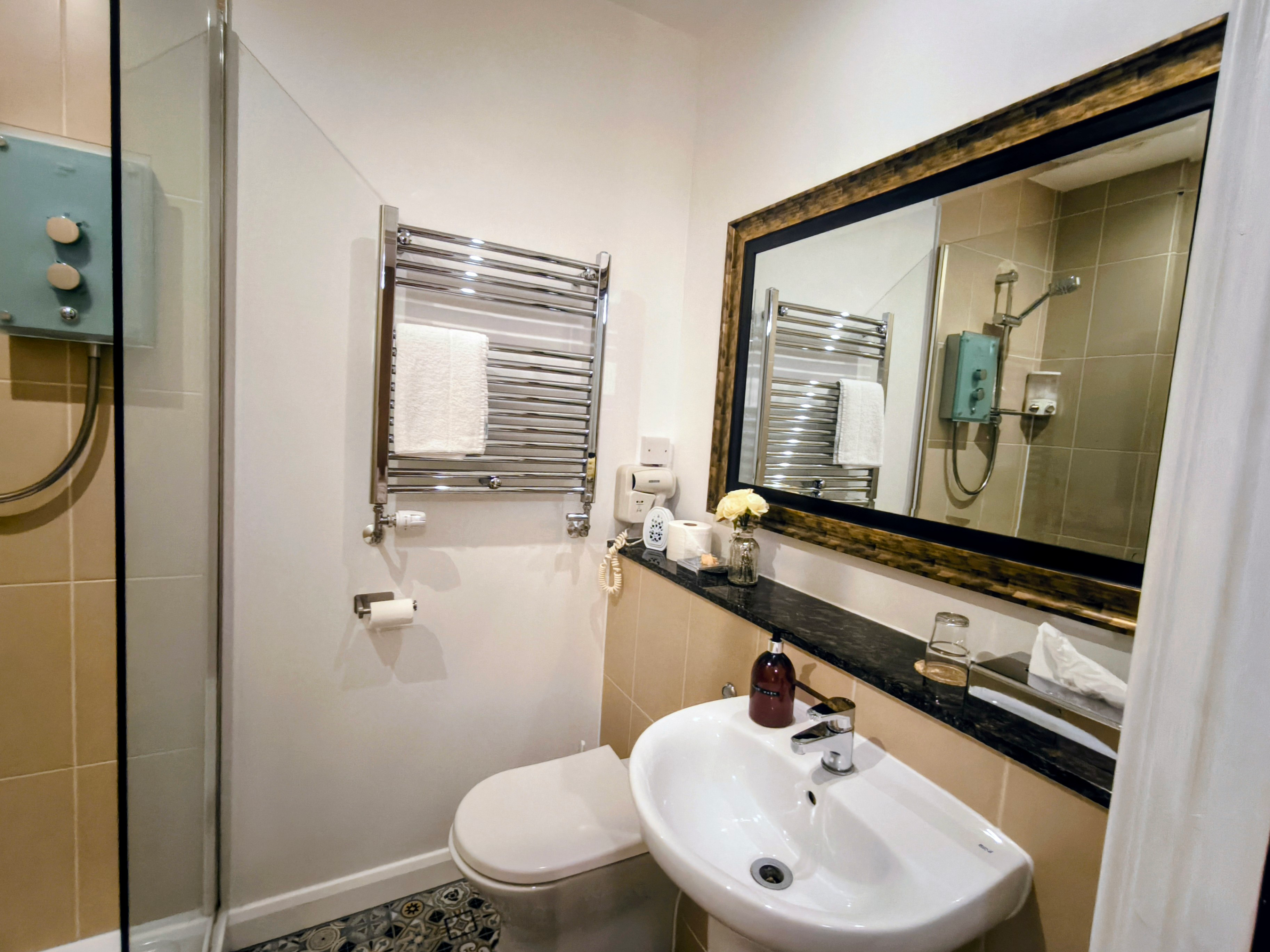 Mosaic floor, large stylish mirror sink, toilet & shower with glass screen & heated rail