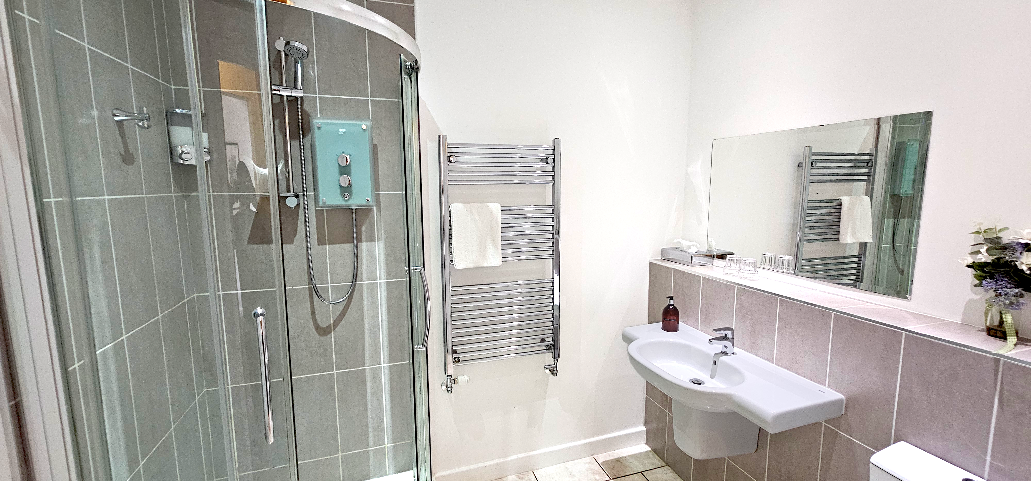 Large bathroom with with corner shower